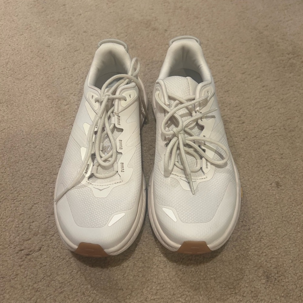 Women transport Hoka sneakers